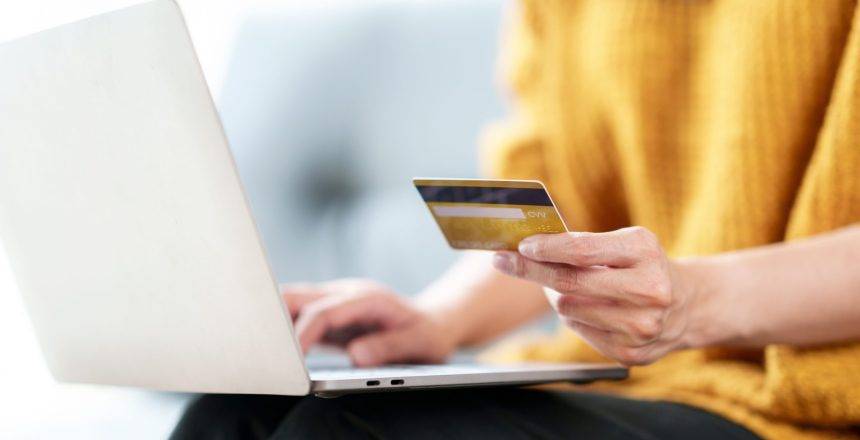 close-up-woman-using-credit-card-on-laptop-compute-2023-11-27-05-34-38-utc2